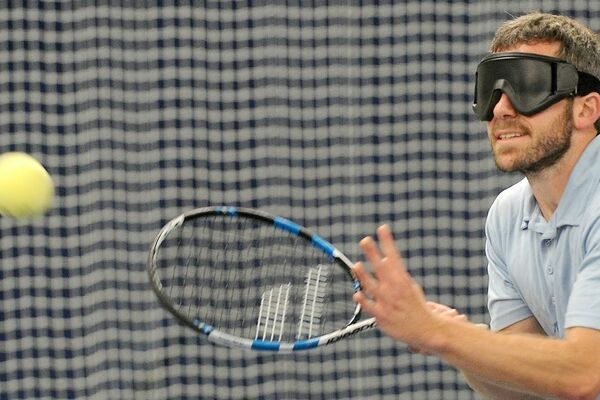 Photo of a person playing tennis