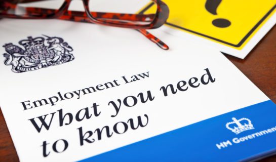 Employment Law leaflet on desk with pair of glasses