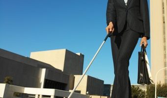 Person with long cane walking to work