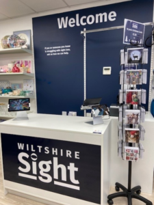 Our sales counter - a white till area with our Welcome sign and logo in white text on dark blue background.