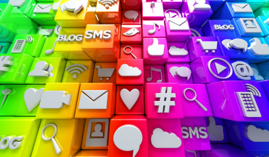 An array of brightly coloured buttons found on a mobile device. they are arranged in colours green yellow orange red purple and blue and are many icons you would find on social media.