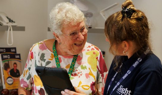 Our Digital Inclusion officer is speaking to a lady, she is holding a tablet and they are deep in coversation