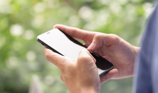 Hands holding a smartphone.